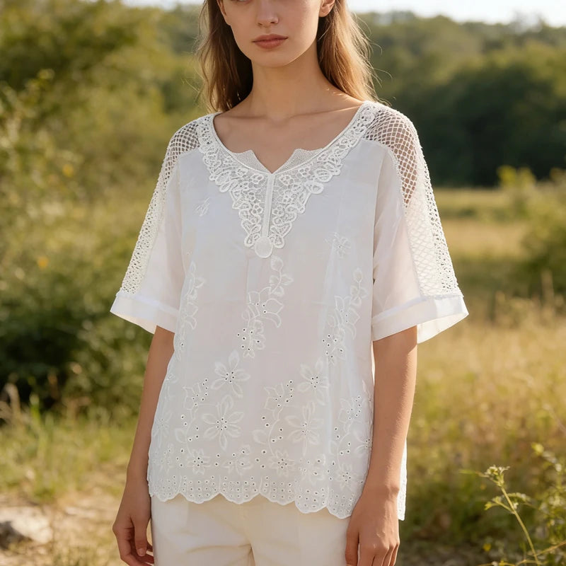 Woman wearing a white lace blouse in a natural setting