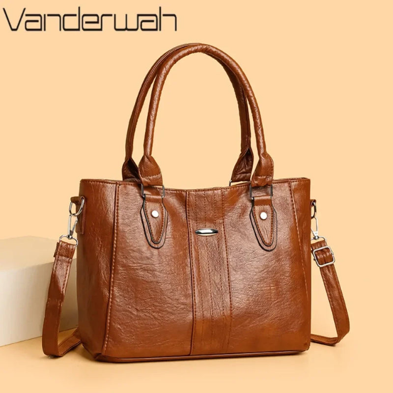 Brown handbag with shoulder strap on a beige background, featuring the brand 'Vanderwah'.