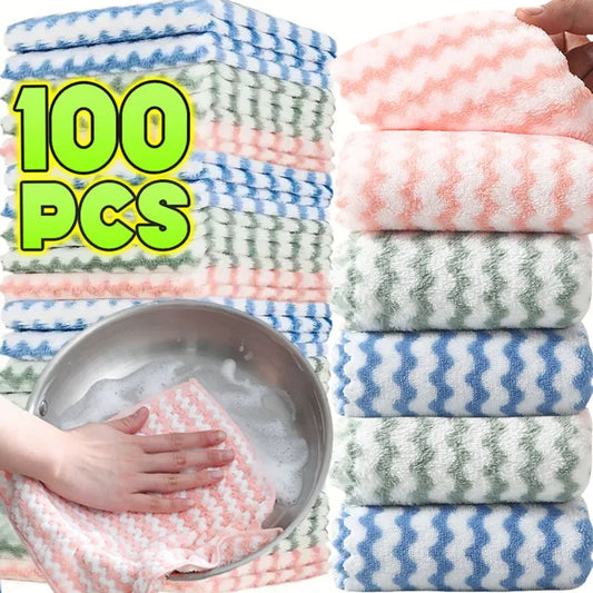 Stacks of colorful patterned cloths with a bowl of soapy water and hands using a cloth.