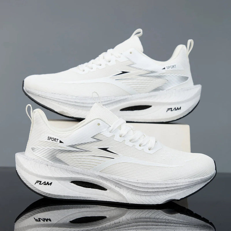White athletic shoes with black accents on a reflective surface and gray background