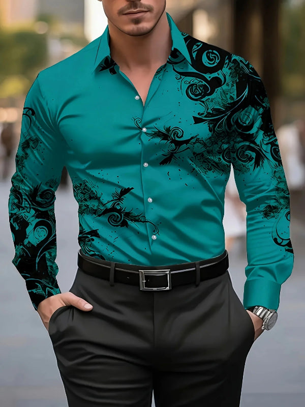 Man wearing a teal shirt with black floral patterns and black pants.