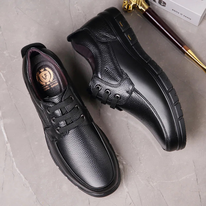Black leather shoes on a light gray surface