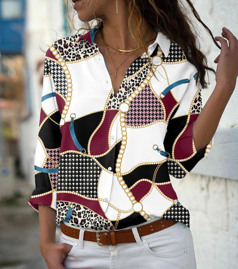 Woman wearing a patterned blouse with a blurred background