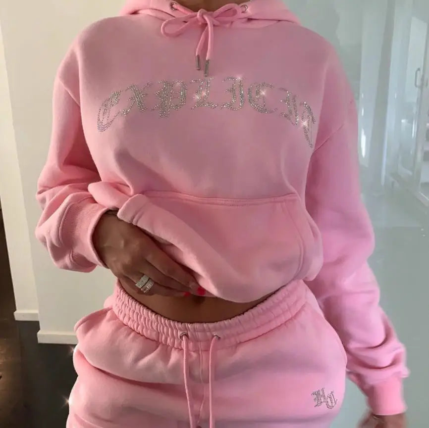 Pink hoodie and pants set with 'EXPLORE' text on a plain background