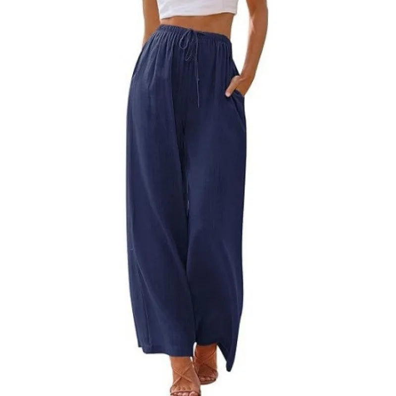 Navy blue wide-leg pants worn by a person on a white background