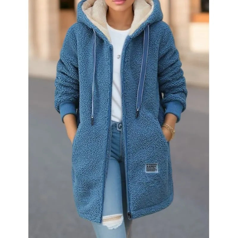 Blue fleece jacket worn by a person with a blurred background