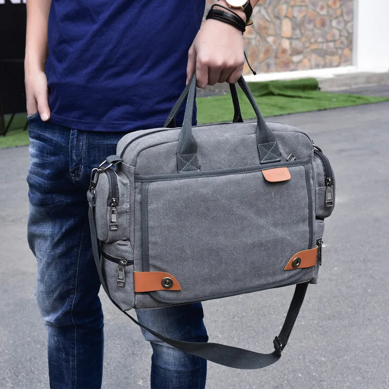 Person holding a gray backpack with brown accents outdoors.