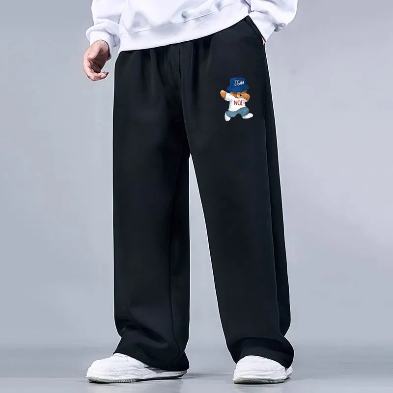 Black pants with a small embroidered design on a gray background
