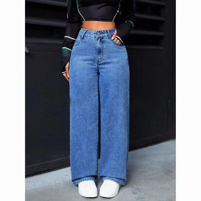 Person wearing blue wide-leg jeans against a black background