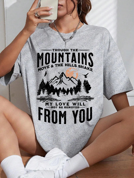 Person wearing a gray t-shirt with a mountain design and text.