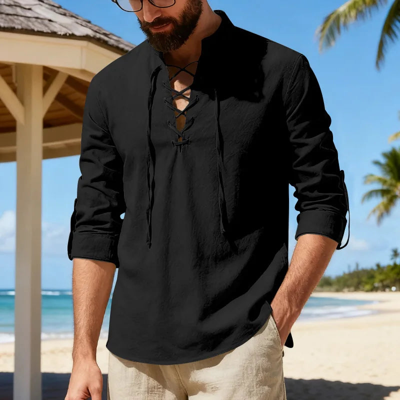 Man wearing a black shirt with a beach and palm trees in the background