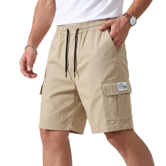 Beige cargo shorts worn by a person on a white background