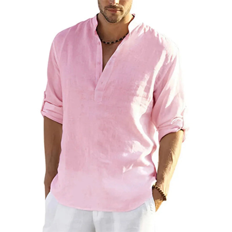 Man wearing a pink shirt with rolled-up sleeves on a white background