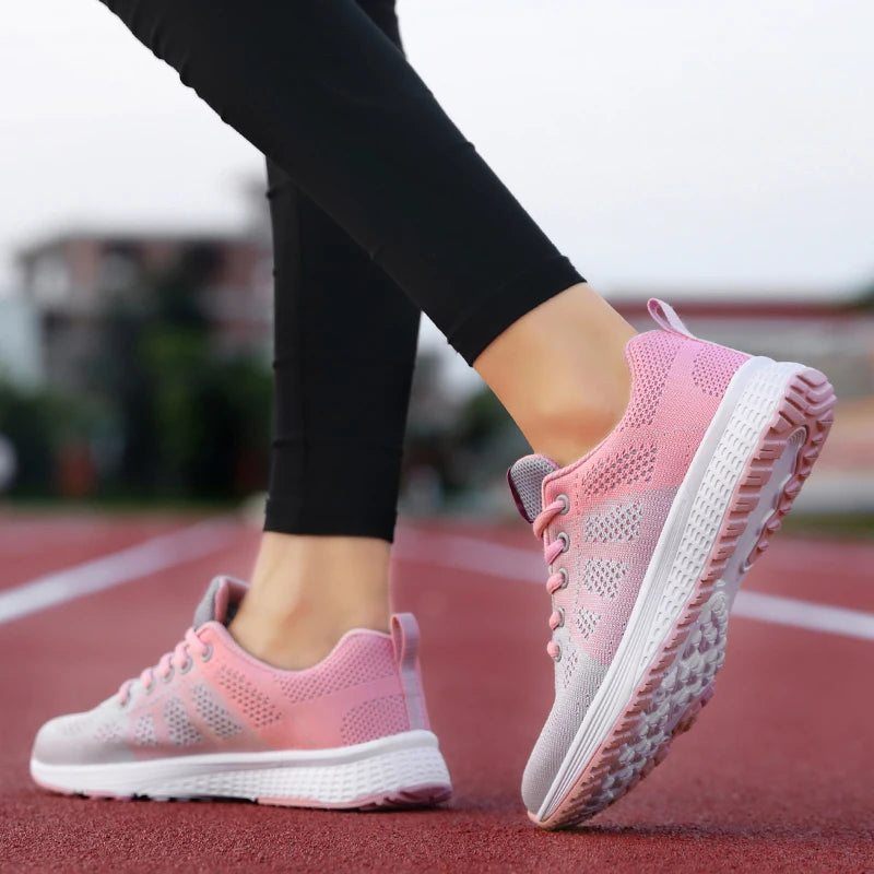 Pink running shoes on a blurred track background