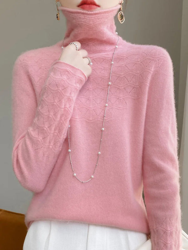 Pink turtleneck sweater worn by a person with a neutral background