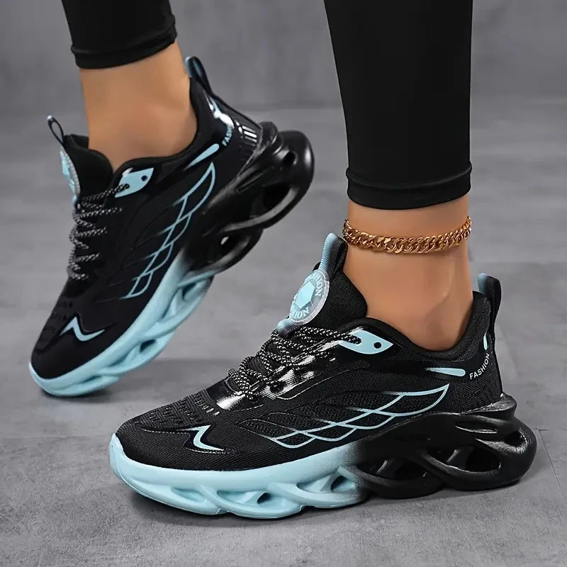 Black and blue sneakers worn by a person on a gray background
