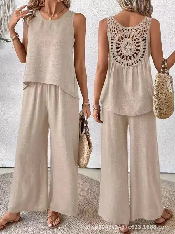 Woman wearing a beige sleeveless top and wide-leg pants with a textured back design, holding a straw bag.