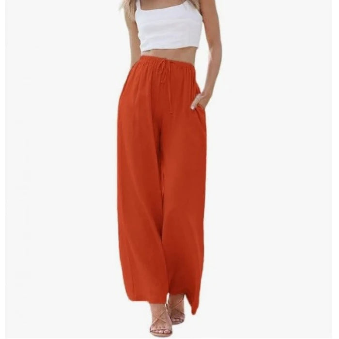 Orange wide-leg pants worn by a person on a white background