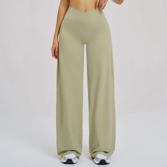 Person wearing olive green wide-leg pants on a plain background