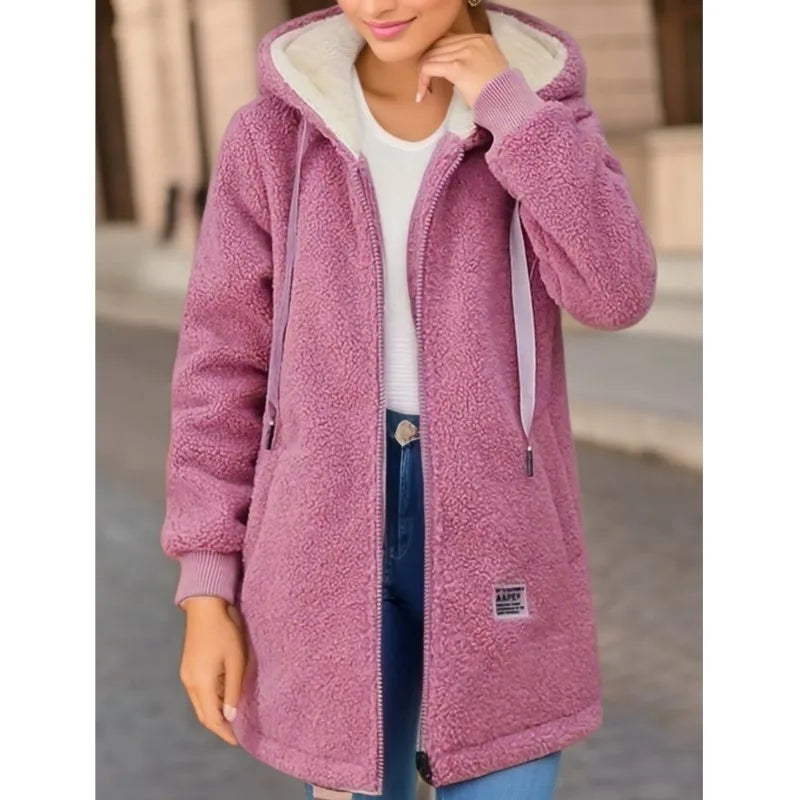 Pink fleece jacket worn by a person with a blurred background