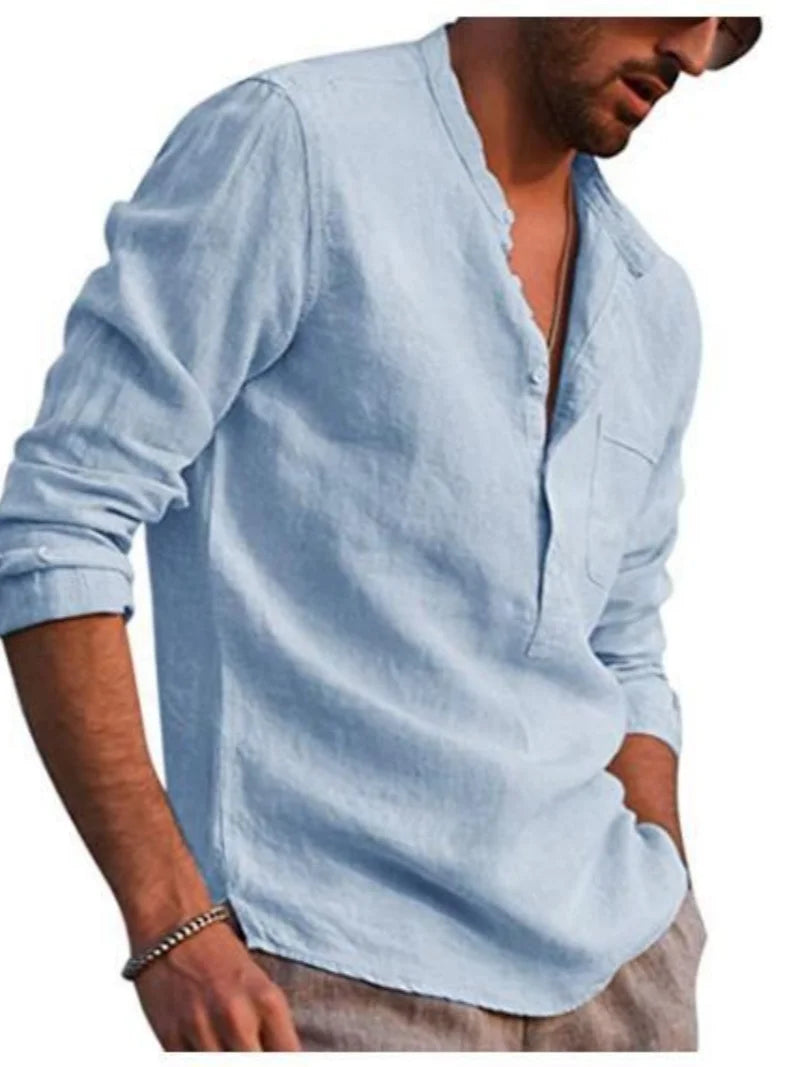 Man wearing a light blue long-sleeve shirt with rolled-up sleeves on a white background