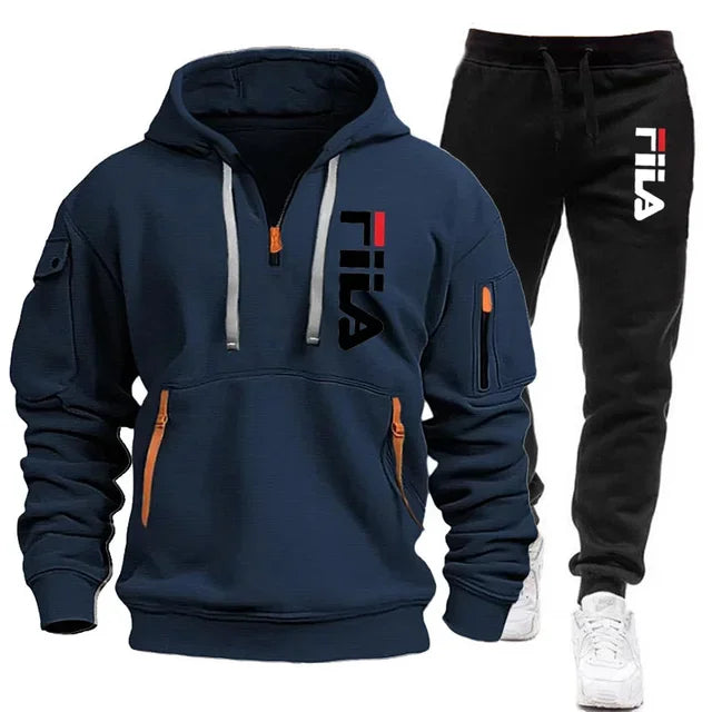 Navy hoodie and black pants with Fila logo on a white background