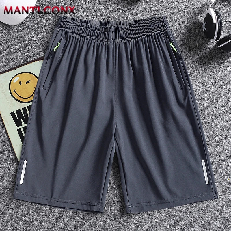 Gray shorts with zippers on a gray background, featuring the brand 'MANTLCONX'.
