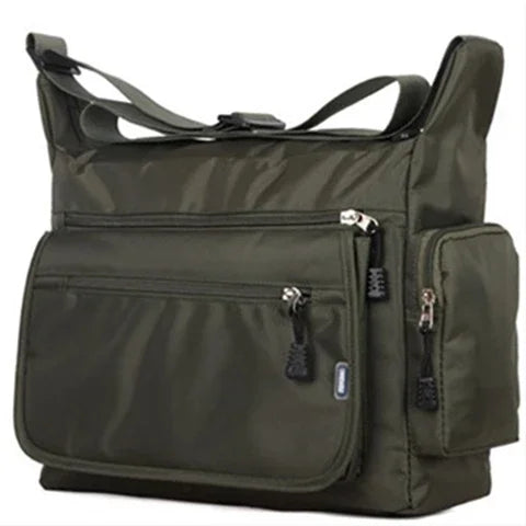 Green shoulder bag with multiple pockets and zippers on a white background