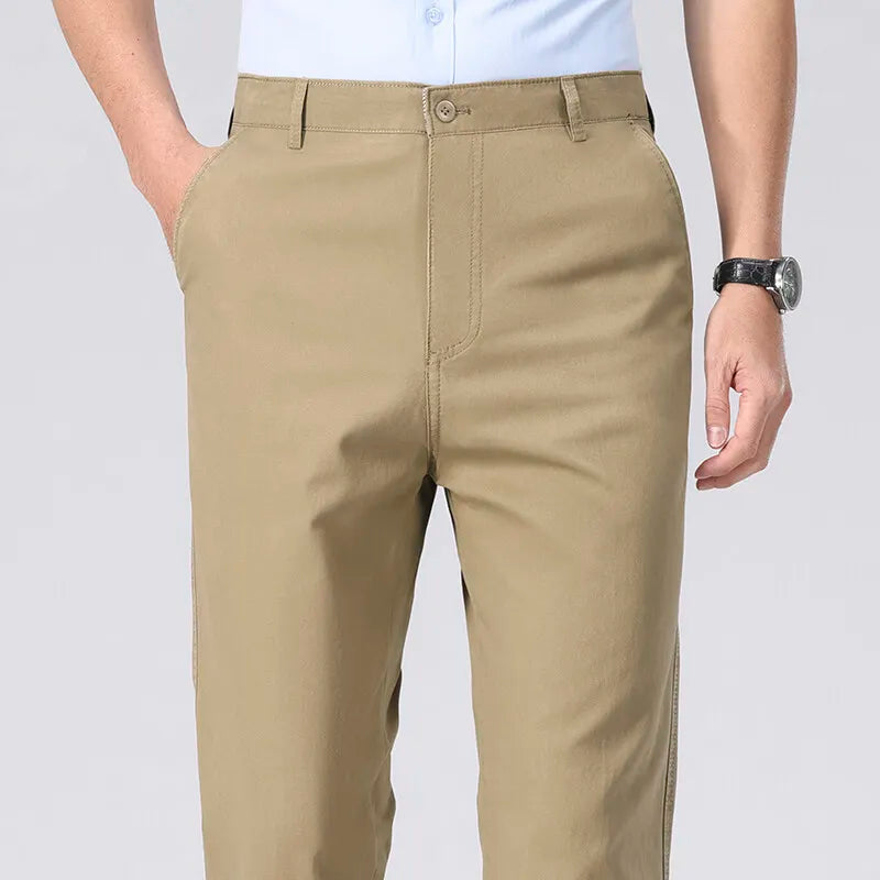 Beige pants worn by a person on a plain background
