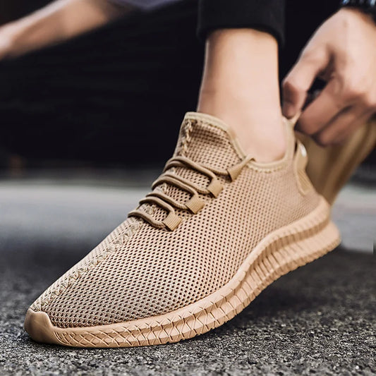 Beige sneaker worn by a person on a blurred background