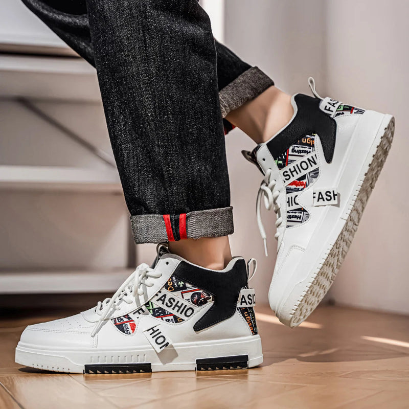 White sneakers with fashion-themed design worn by a person on a wooden floor.