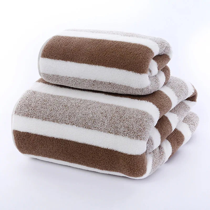 Stack of brown and white striped towels on a white background