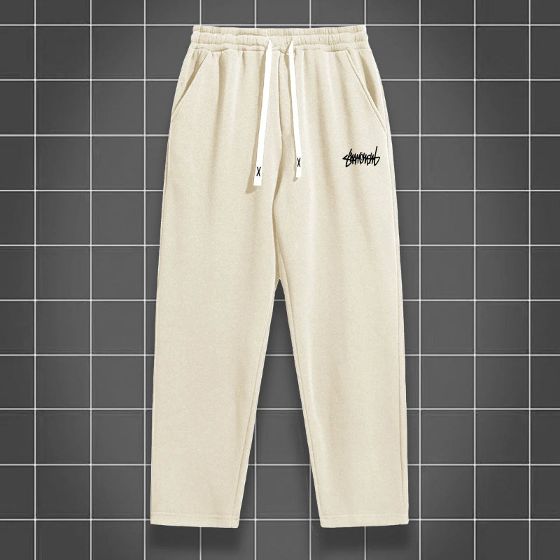 Beige sweatpants with a logo on a grid background