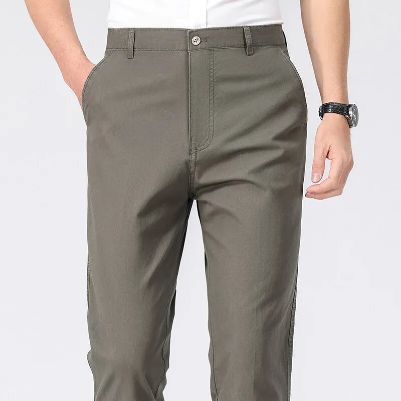 Green pants worn by a person on a white background
