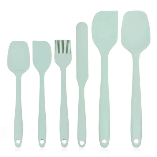 Set of light blue silicone spatulas and utensils on a white background