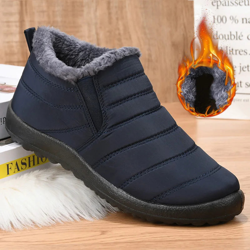 Blue winter boot with gray fur lining on a wooden surface