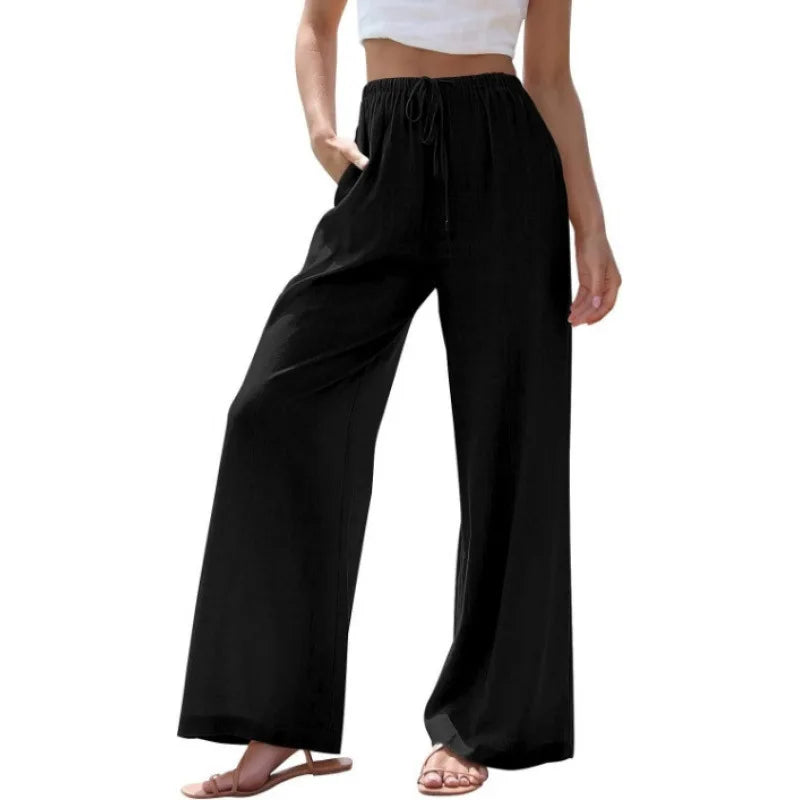 Black wide-leg pants worn by a person on a white background