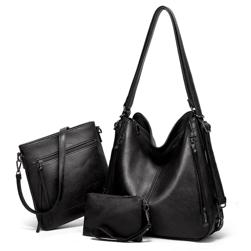 Set of black handbags including a large shoulder bag, smaller handbag, and matching wallet on a white background.