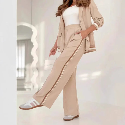 Person wearing a beige suit with white stripes in an indoor setting