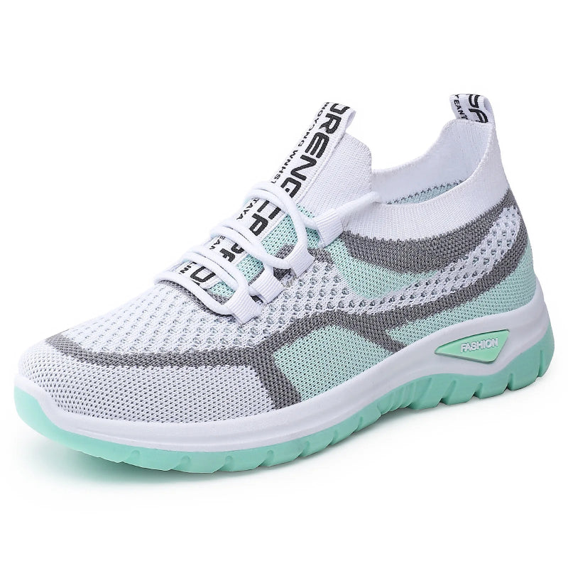 White and gray sneaker with green sole on a white background