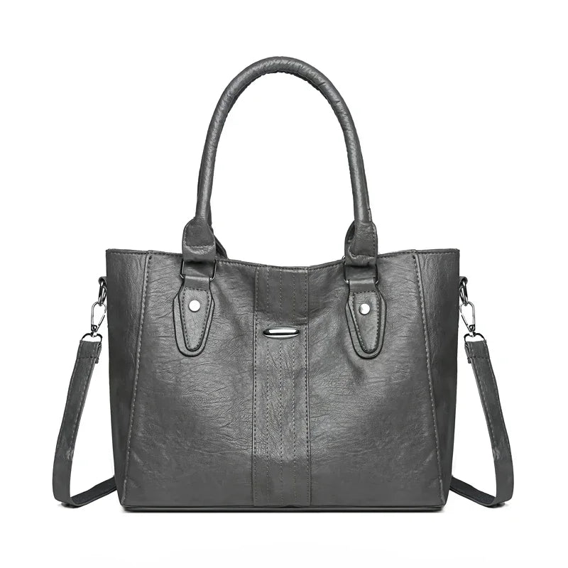 Black handbag with shoulder strap on a white background