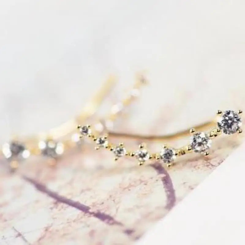 Gold and silver beaded earrings on a light background