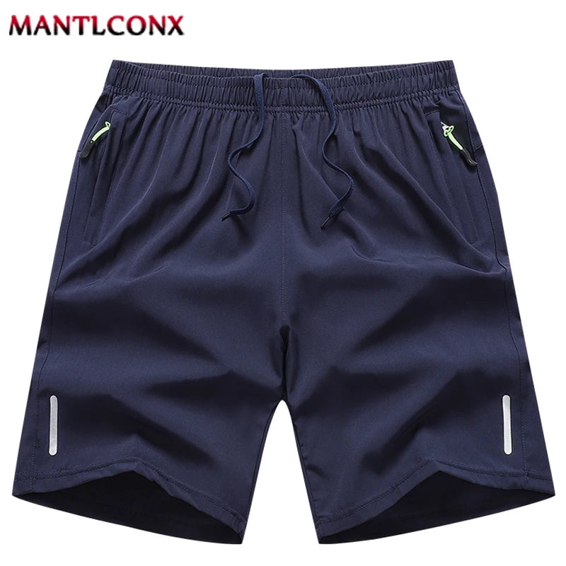 Navy blue shorts with drawstring and side zippers on a white background, branded 'MANTLCONX'.