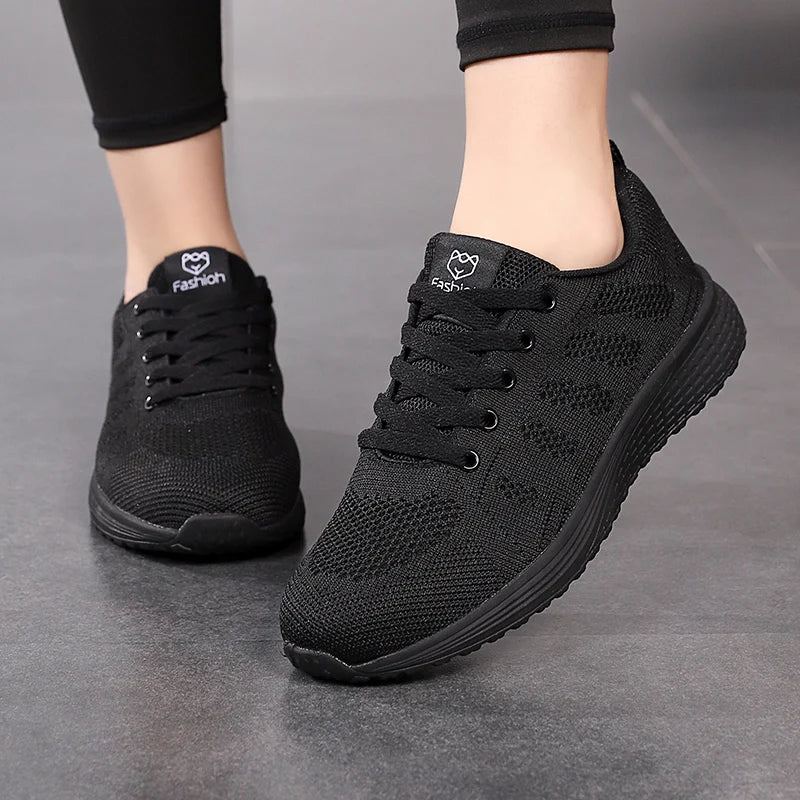 Black athletic shoes on a gray background