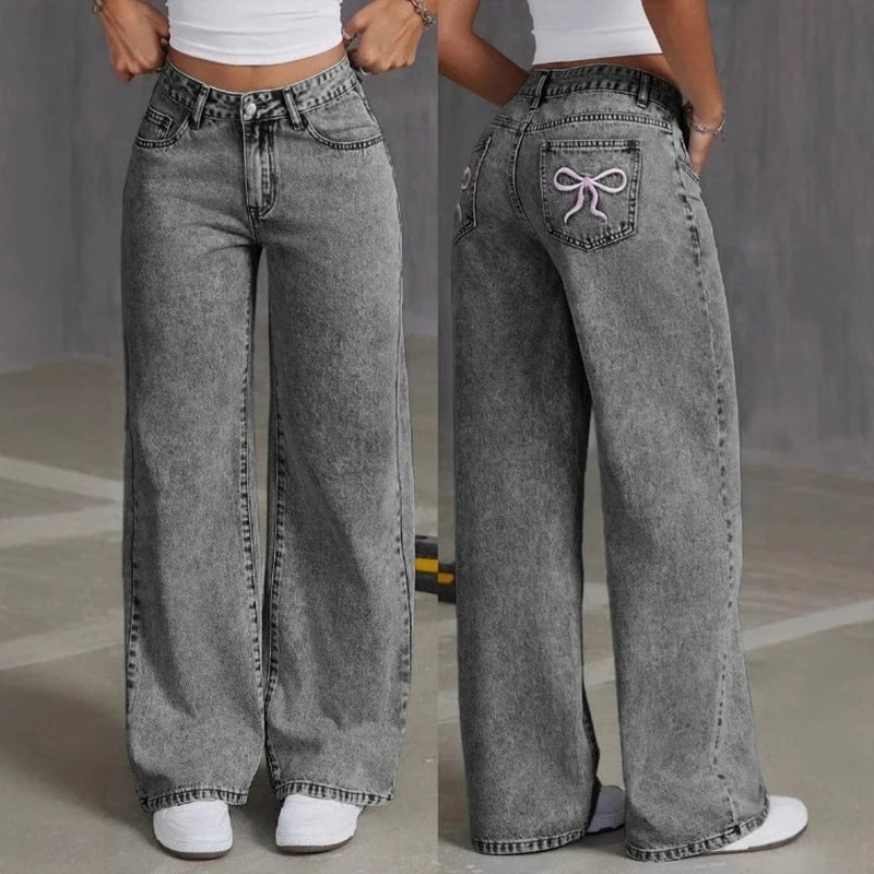 Gray wide-leg jeans with a decorative pocket detail on a neutral background