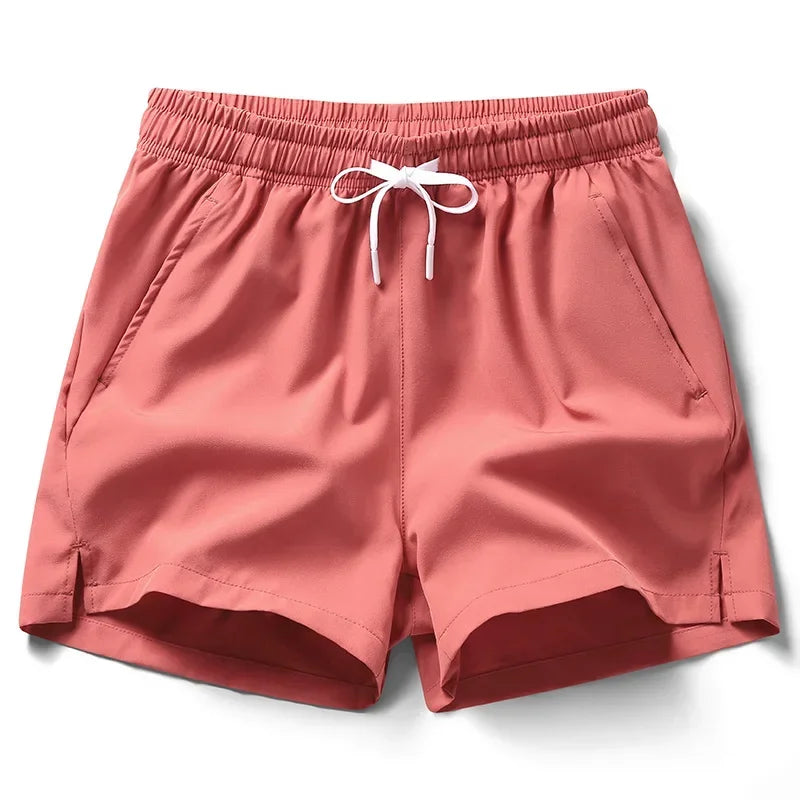 Pink shorts with a drawstring on a white background