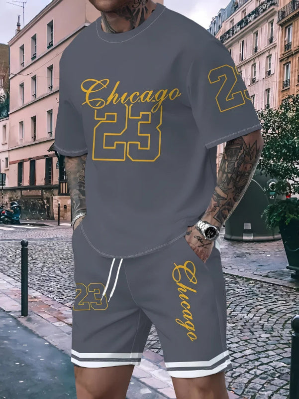 Person wearing a gray 'Chicago 23' t-shirt and shorts set on a city street.