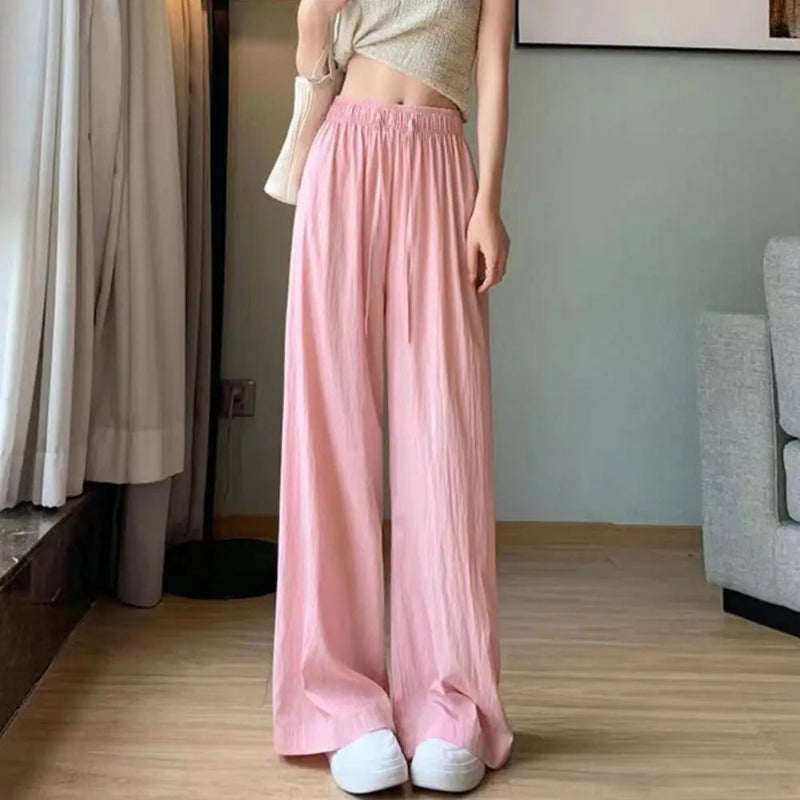 Person wearing a light pink skirt in a room with neutral decor