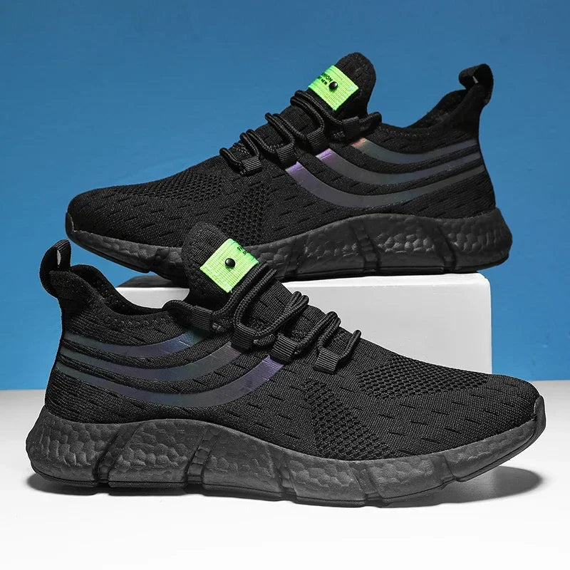 Black athletic shoes with green accents on a blue and white background