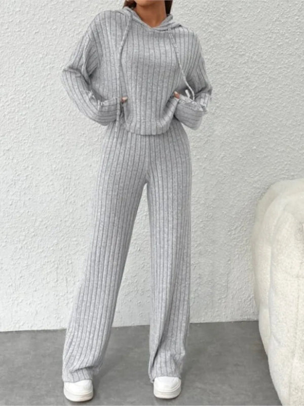Person wearing a gray ribbed knit outfit against a white background
